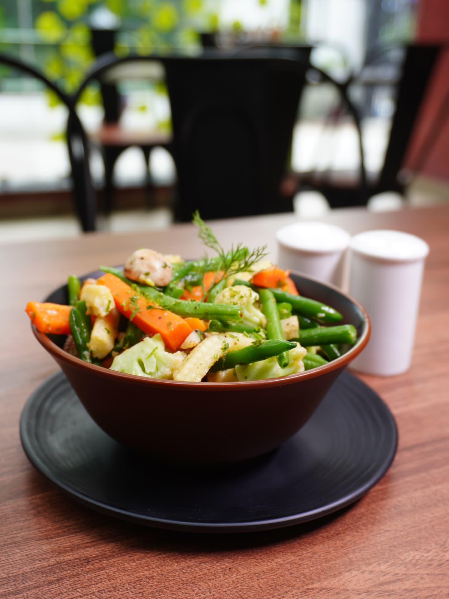 Stir-fried vegetables in a bowl with beans, carrots and baby corn